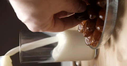 Dates and milk pouring slow-motion, breaking fast during ramadan, studio 스톡 동영상 264858133