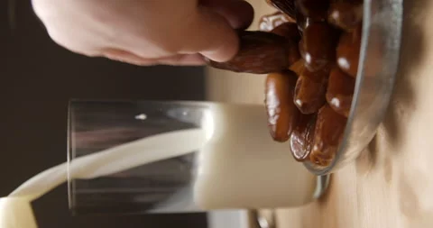 Dates and milk pouring slow-motion, breaking fast during ramadan, studio Video stock 264858210