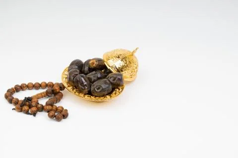 Dates and Rosary on white background Foto stock
