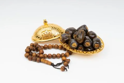 Dates and Rosary on white background Foto stock