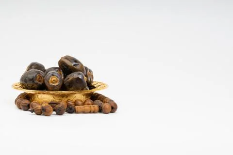 Dates and Rosary on white background Foto stock