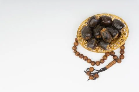 Dates and Rosary on white background Foto stock