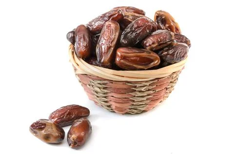 Dates in a basket on a white background with soft shadow Stock Photos