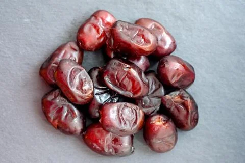 Dates on a black chalkboard. Dried dates top view. Stock Photos