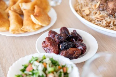 Dates on dining table served with rice and water for iftar  with arabian food Stock Photos