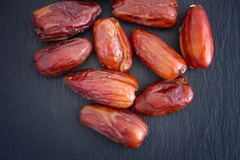 Dates Fruit on a Black Slate Background Stock Photos