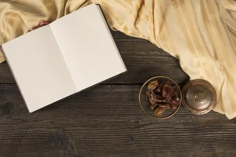 Dates fruit bowl with blank notebook Fotos de archivo