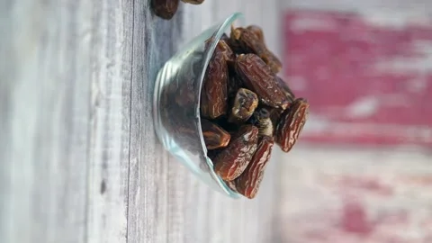 Dates fruit in glass bowl for iftar time close up view on table dynamic mov.. Stock Footage 332908126