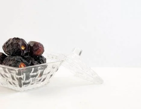 Dates in glassware over white. High in natural sugar. Stock Photos