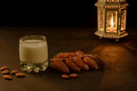 Dates, milk and lantern on stone table. Muslim holy month Ramadan Kareem. Cop Stock Photos