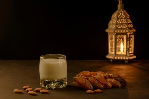 Dates, milk and lantern on stone table. Muslim holy month Ramadan Kareem. Cop Stock Photos