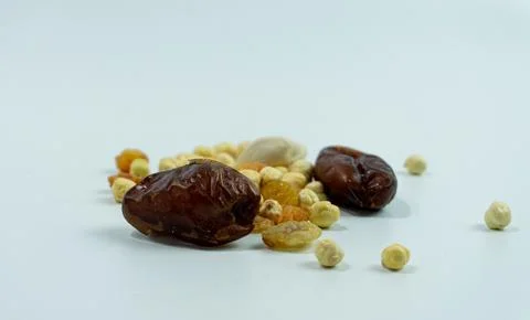 Dates, raisins and chickpeas on a white background Stock Photos