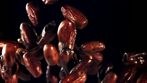 Dates rise up and rotate in flight. Filmed on a high-speed camera at 1000 fps. Stock Footage 202140197