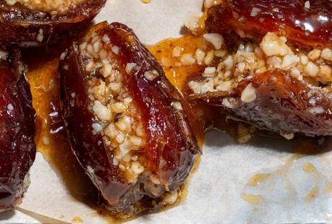 Dates stuffed with nuts and pepper and cooked in honey Stock Photos