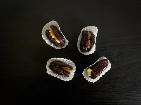 Dates stuffed with nuts on a table Stock Photos