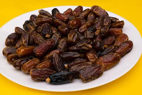 Dates in white plate (eenthapazham) Stock Photos