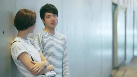Dating couple talking by the wall Stock Footage 147600871