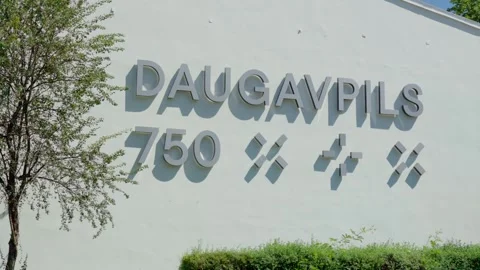 Daugavpils sign on white wall facade in city center, Latvia regional Stock Footage 342685420