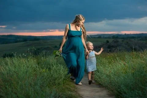 Daughter and mother walking outdoors. Happy family. Stock Photos