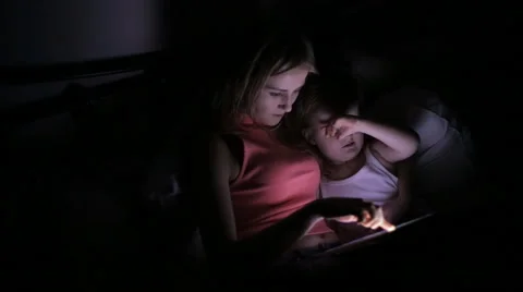 Daughter in bed playing with tablet Video stock 59114863