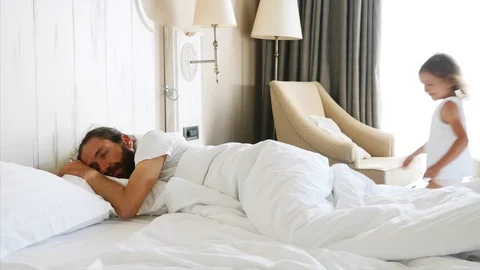 Daughter comes to sleeping father and st... | Stock Video | Pond5