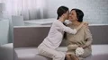 Daughter congratulating mother on her birthday, warm greetings, gift and flowers HD Footage