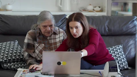 Daughter Devotion: Guiding Mom Through Online Business Stock-Footage 310653289