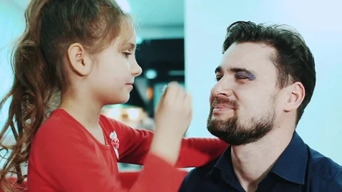 Daughter doing make-up to her dad Video stock 72197954