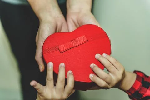 Daughter gives gift box to mum, top view. Stock Photos
