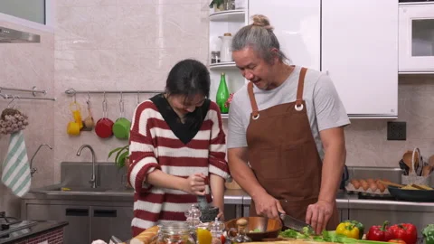 Daughter help her father for preparing food. Stock Footage 134369529
