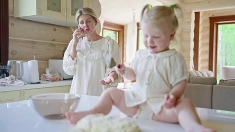 Daughter Helping Mom Bake in the Kitchen Stock Footage 280679512