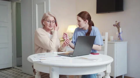 Daughter helps an elderly mother learn new technologies. She helps a pensioner Stock Footage 174015492