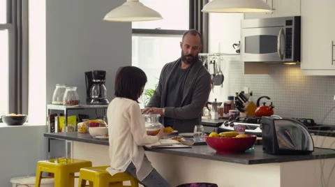 Daughter interacting with father in kitchen Stock Footage 63860868