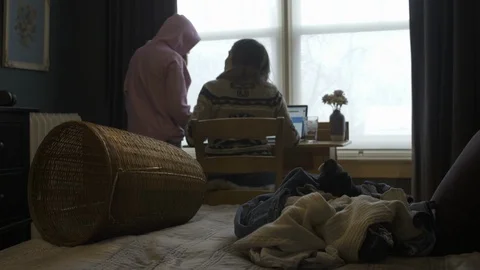 Daughter Interupts Self Isolating Mum Working in Bedroom Stock Footage 127125854