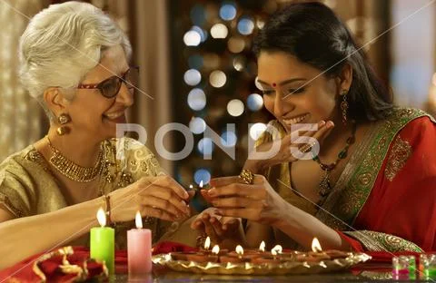 Daughter in law decorating the house with mother in law on the occasion of Stock Photos