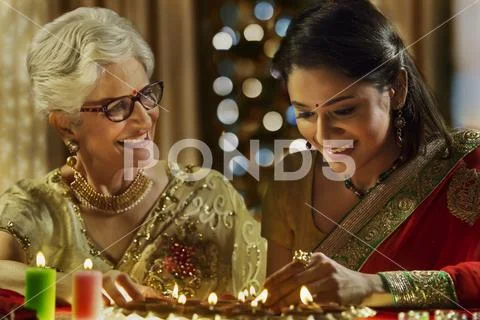 Daughter in law decorating the house with mother in law on the occasion of Stock Photos