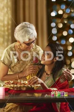 Daughter in law decorating the house with mother in law on the occasion of Stock Photos