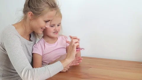 Daughter playing with hand spinner Stock-Footage 77213629