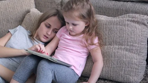Daughter playing with tablet Stock-Footage 71344668