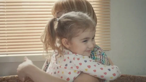 Daughter Rushes Into Mother's Arms At Home Across From the Window. Slow motio Stock Footage