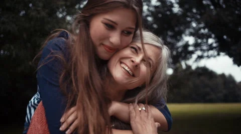 Daughter Surprises Mother With a Hug From Behind Stock Footage