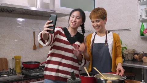 Daughter using smartphone for video call with her mother in kitchen Stock Footage 134368174