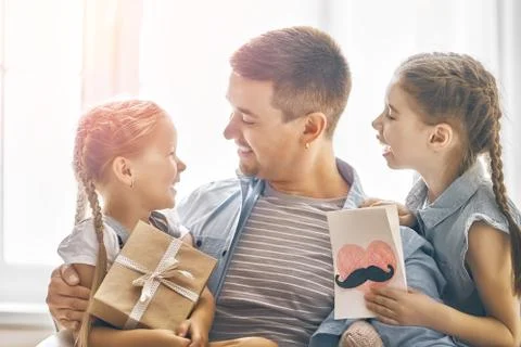 Daughters congratulating dad Stock Photos