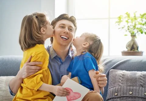 Daughters congratulating dad Stock Photos