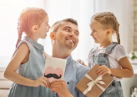Daughters congratulating dad Stock Photos