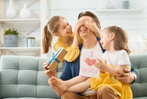 Daughters congratulating dad Stock Photos