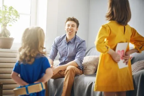 Daughters congratulating dad Stock Photos