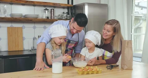 Daughters help parents making breakfast Stock Footage 116337043