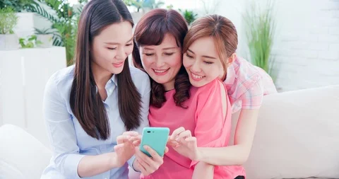 Daughters show smartphone to mom Stock Footage 106789669