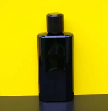 Davidoff Cool Water Eau de Toilette large perfume bottle in front of yellow wall Stock Photos